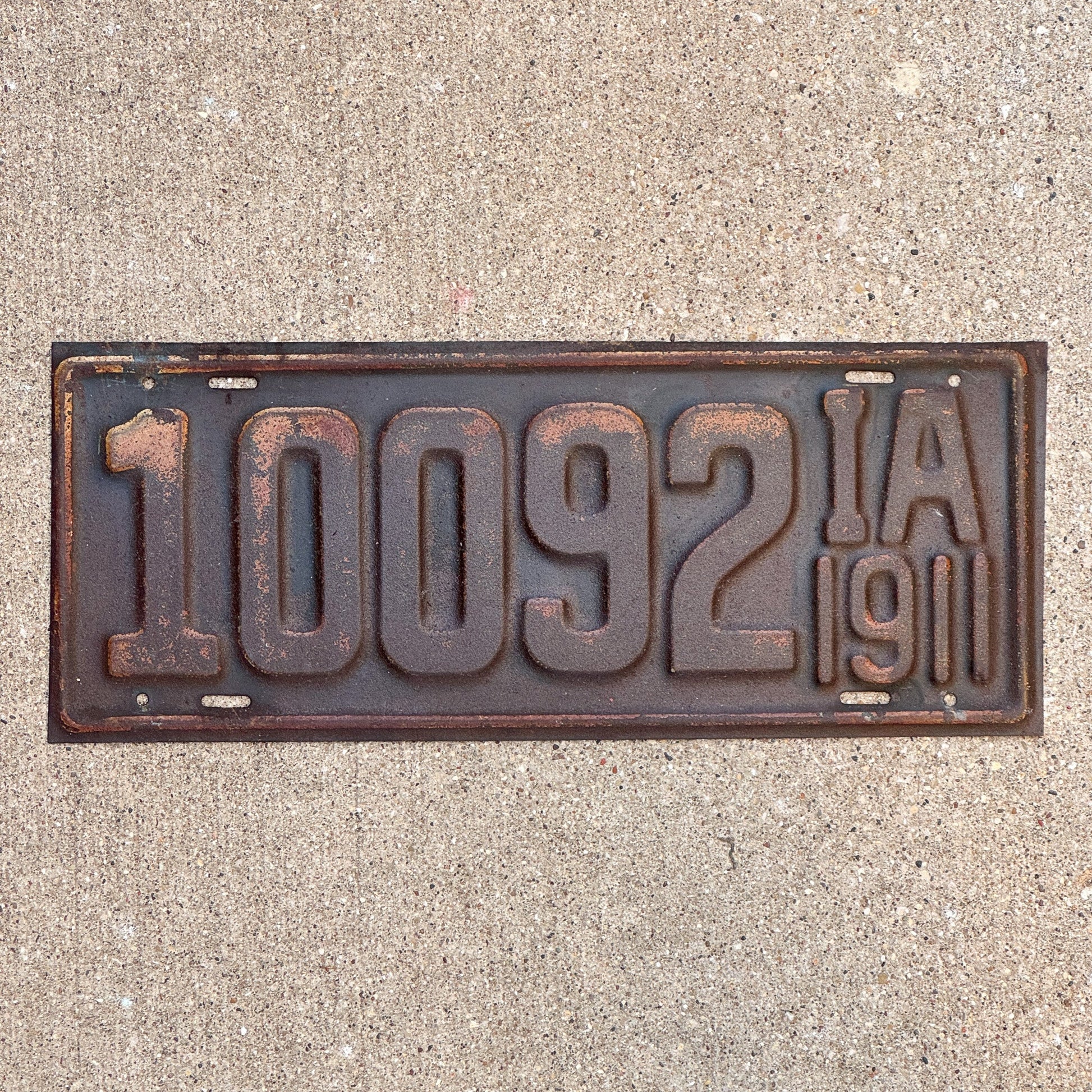 Photo of a 1911 Iowa License Plate Auto Tag 2 Garage Decor First Issue 10092 with original patina