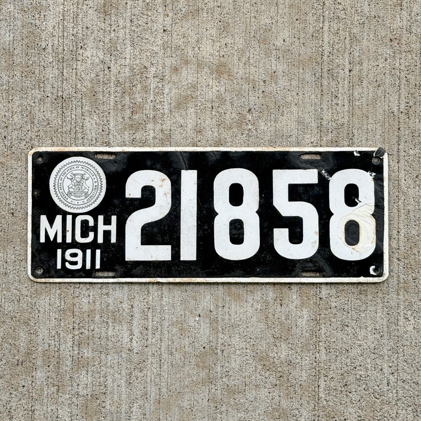 Photo of a 1911 Michigan Porcelain License Plate Auto Tag Garage Decor Vintage 21858 with original patina
