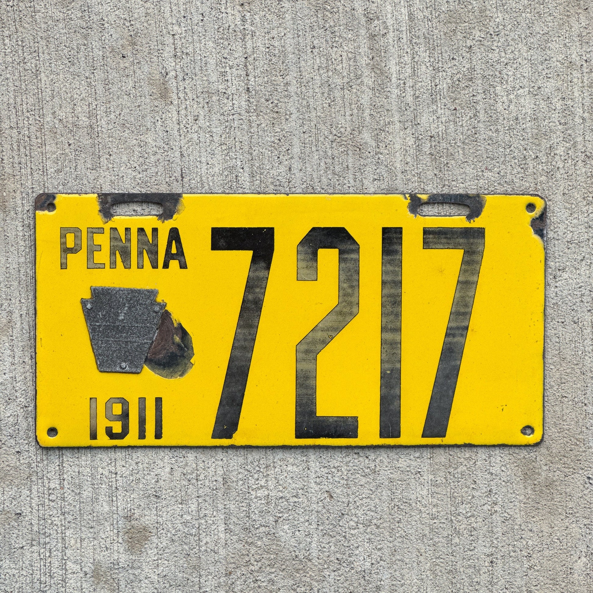 Photo of a 1911 Pennsylvania Porcelain License Plate Auto Tag Garage Decor Vintage Low Number Four Digit 7217 with original patina