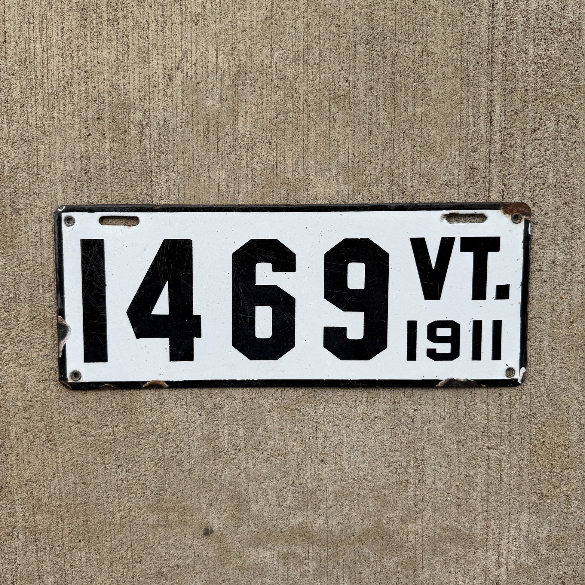 Photo of a 1911 Vermont Porcelain License Plate Auto Tag Garage Decor Vintage Low Number Four Digit 1469 with original patina