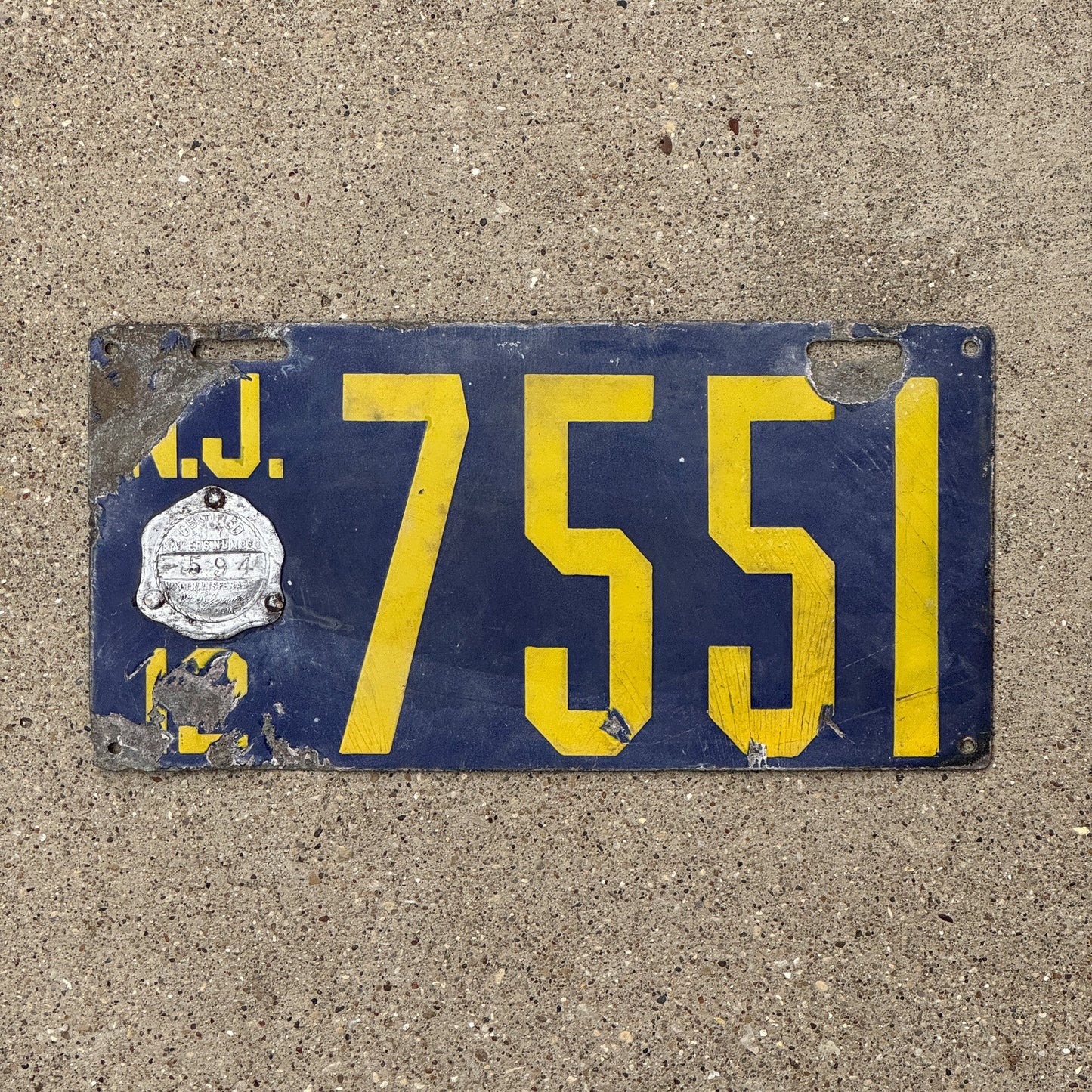 Photo of a 1912 New Jersey Porcelain License Plate Auto Tag Garage Decor Vintage Low Number Four Digit 7551 with original patina