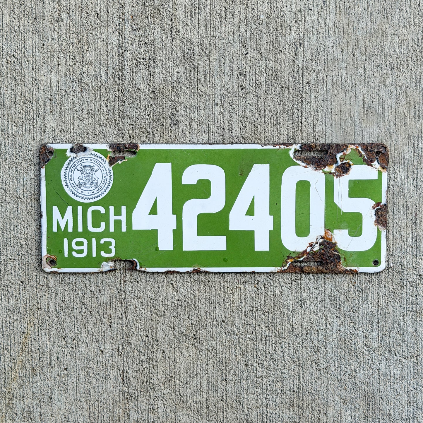 Photo of a 1913 Michigan Porcelain License Plate Auto Tag Garage Decor Vintage 42405 with original patina