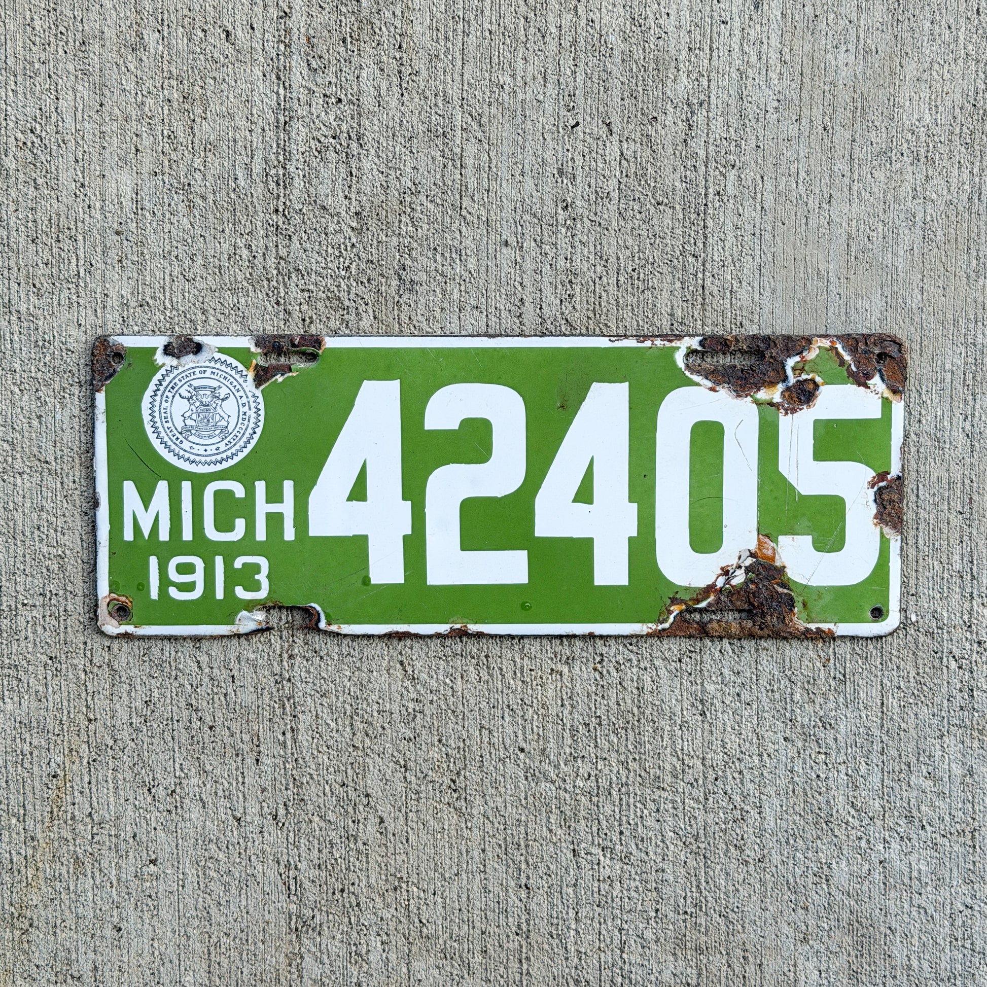 Photo of a 1913 Michigan Porcelain License Plate Auto Tag Garage Decor Vintage 42405 with original patina