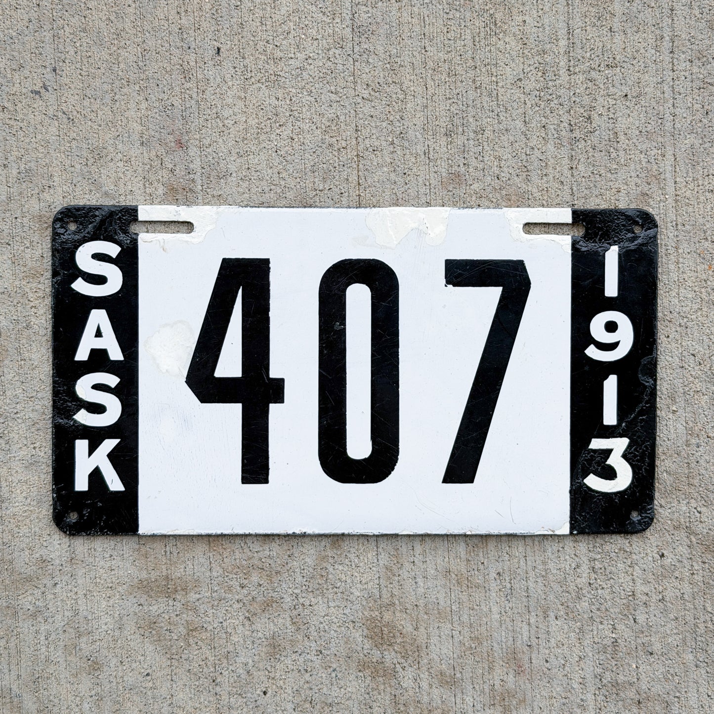 Photo of a 1913 Saskatchewan Porcelain License Plate Auto Tag Garage Decor Vintage 407 with original patina