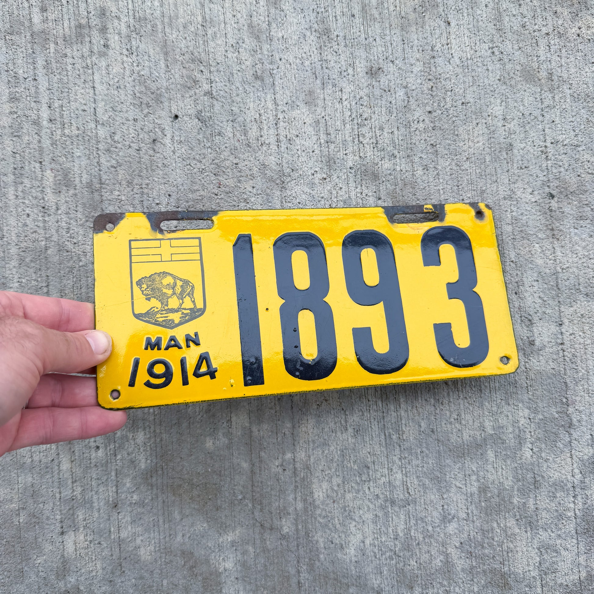 Photo of a 1914 Manitoba Porcelain License Plate Auto Tag Garage Decor Vintage High Quality 1893 with original patina