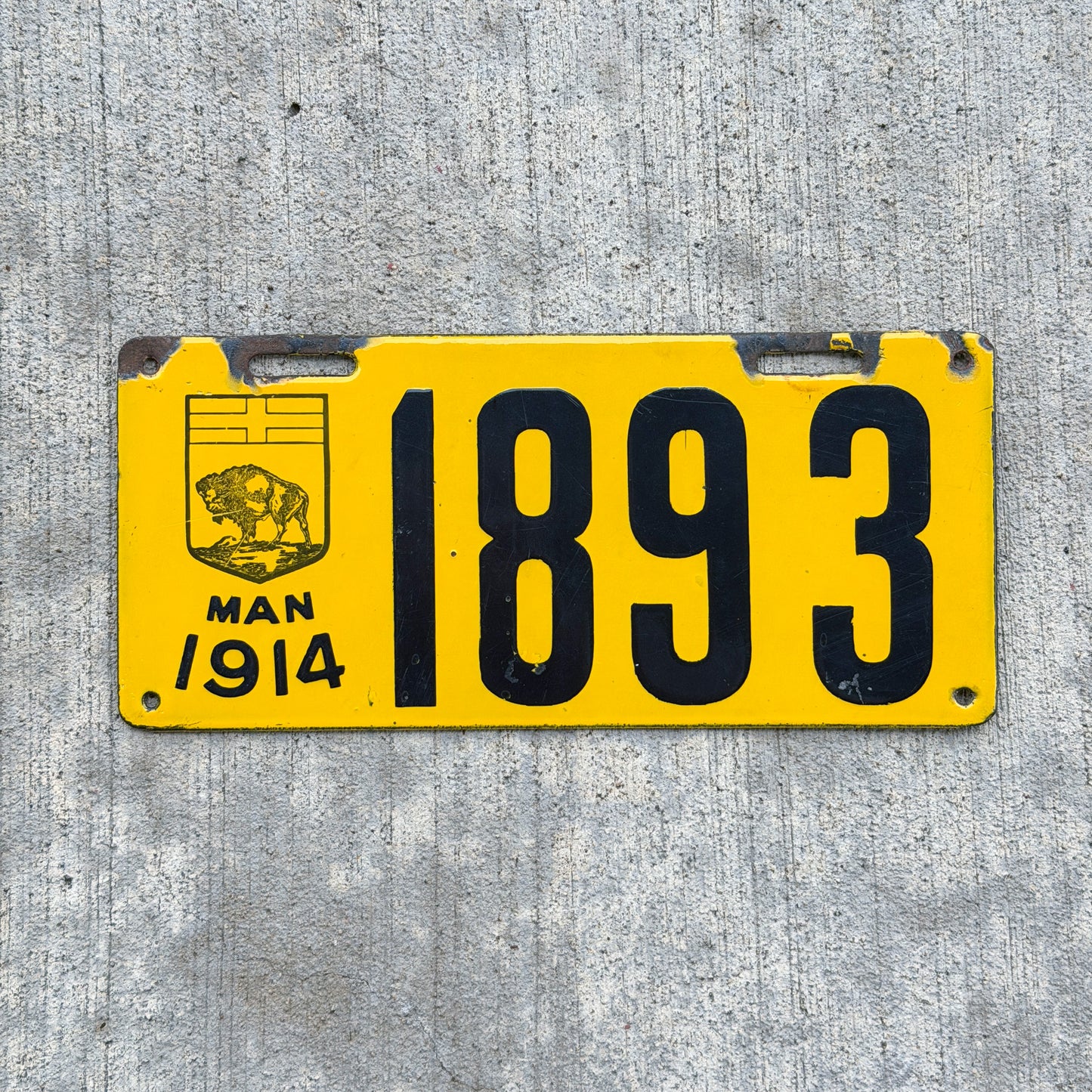 Photo of a 1914 Manitoba Porcelain License Plate Auto Tag Garage Decor Vintage High Quality 1893 with original patina