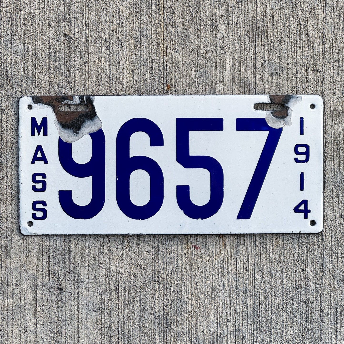 Photo of a 1914 Massachusetts Porcelain License Plate Auto Tag 2 Vintage Garage Low Number Four Digit 9657 with original patina