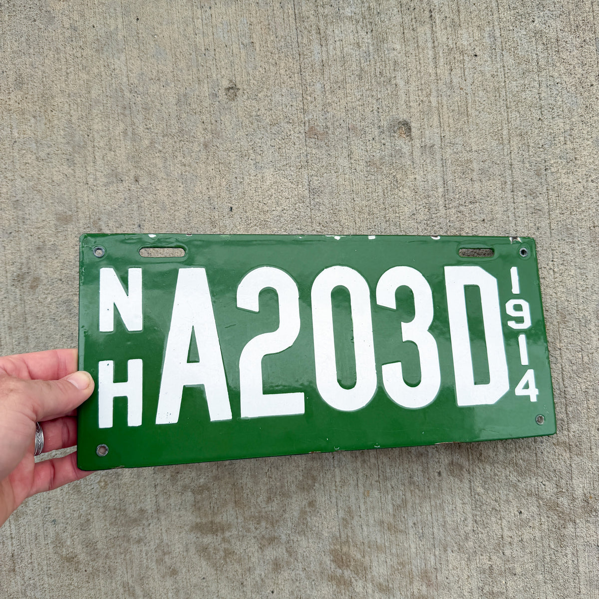 Photo of a 1914 New Hampshire Porcelain Dealer License Plate Auto Tag Garage Decor Vintage High Quality A 203 D with original patina