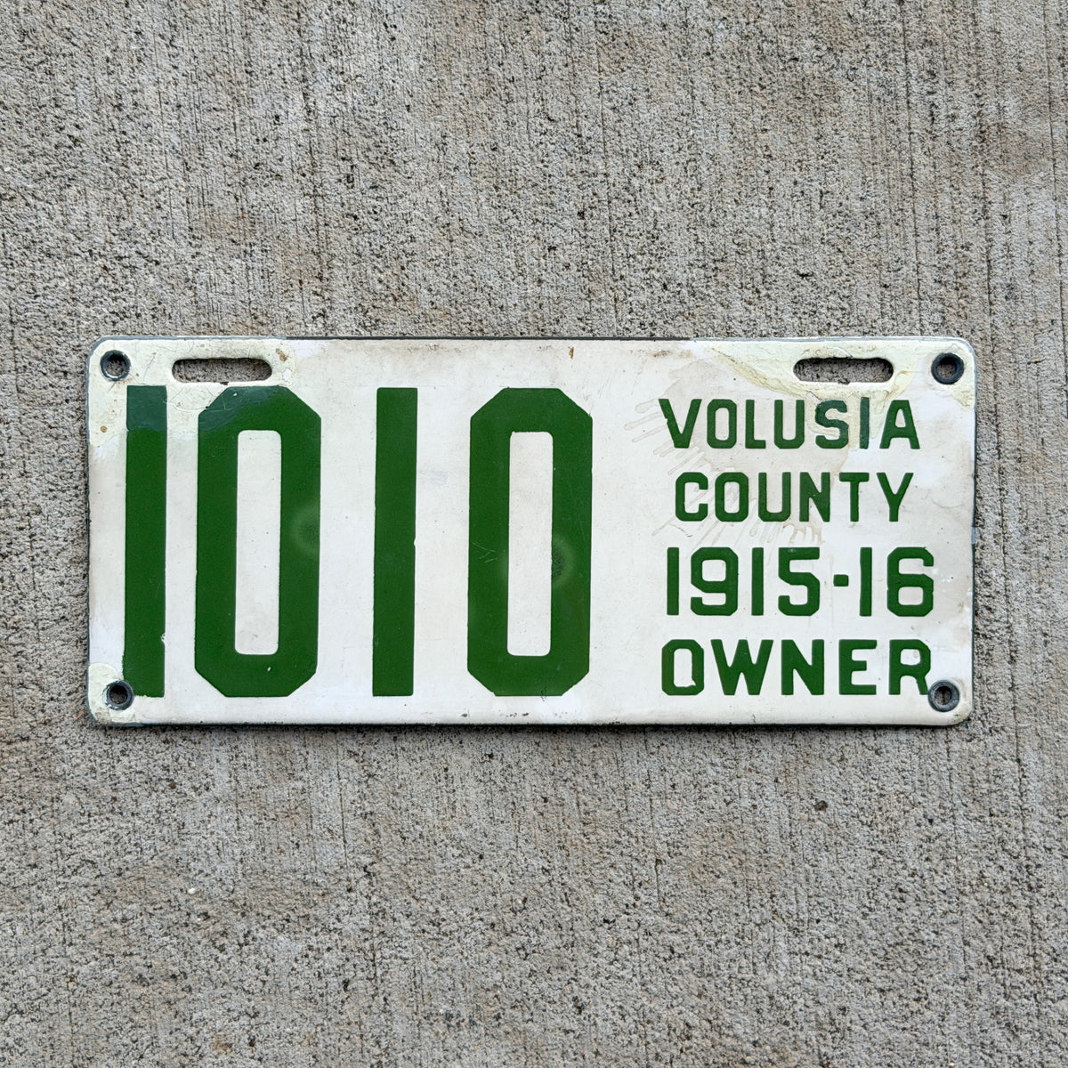 Photo of a 1915 1916 Florida Porcelain License Plate Auto Tag Garage Decor Vintage Volusia County 1010 with original patina