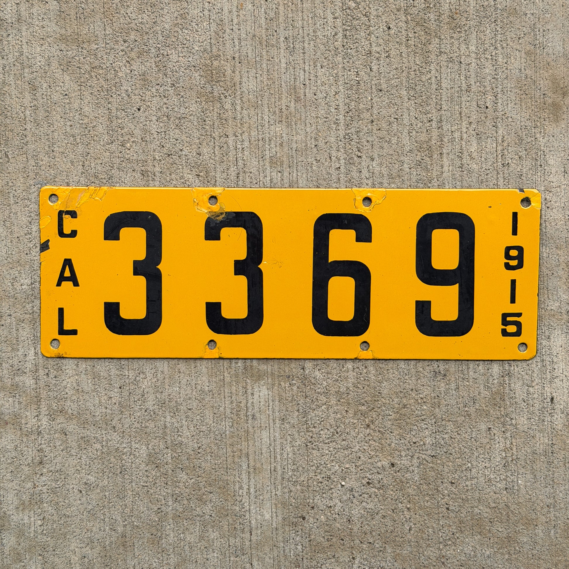 Photo of a 1915 California Porcelain License Plate Auto Tag Garage Decor Vintage Low Number Four Digit 3369 with original patina