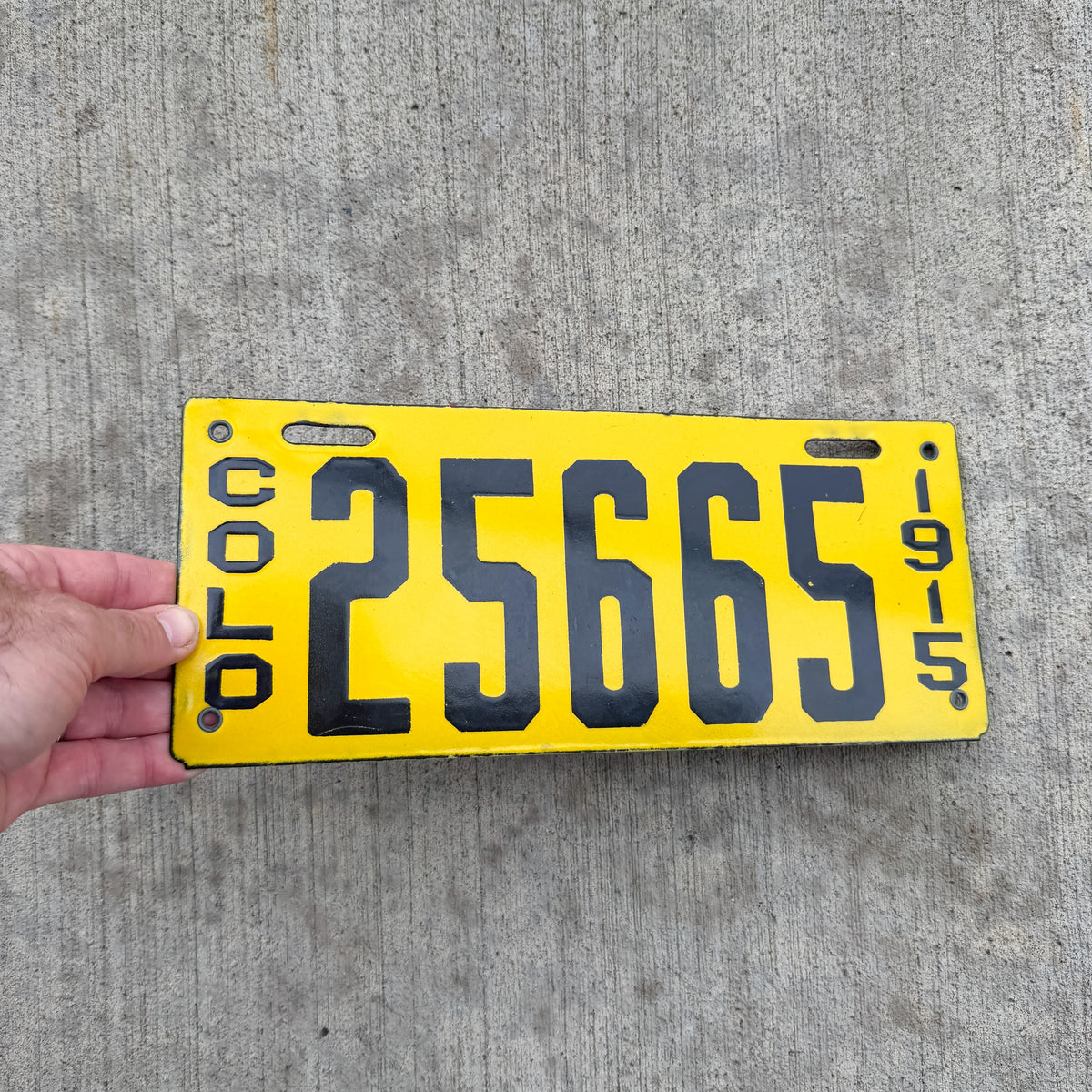 Photo of a 1915 Colorado Porcelain License Plate Auto Tag Garage Decor Vintage High Quality 25665 with original patina