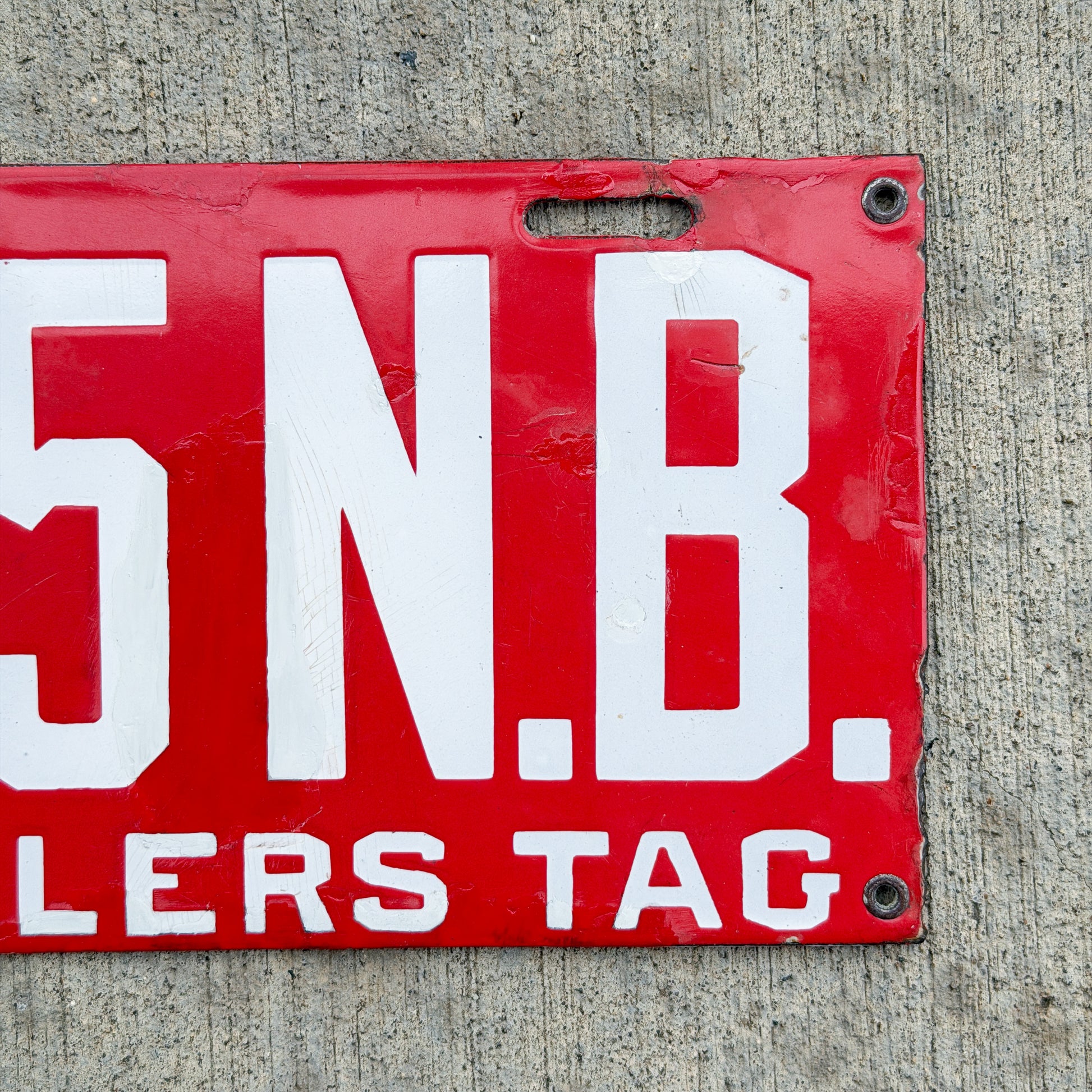 Photo of a 1915 New Brunswick Porcelain Dealer License Plate Auto Tag Garage Decor Vintage Low Number Two Digit 65 with original patina