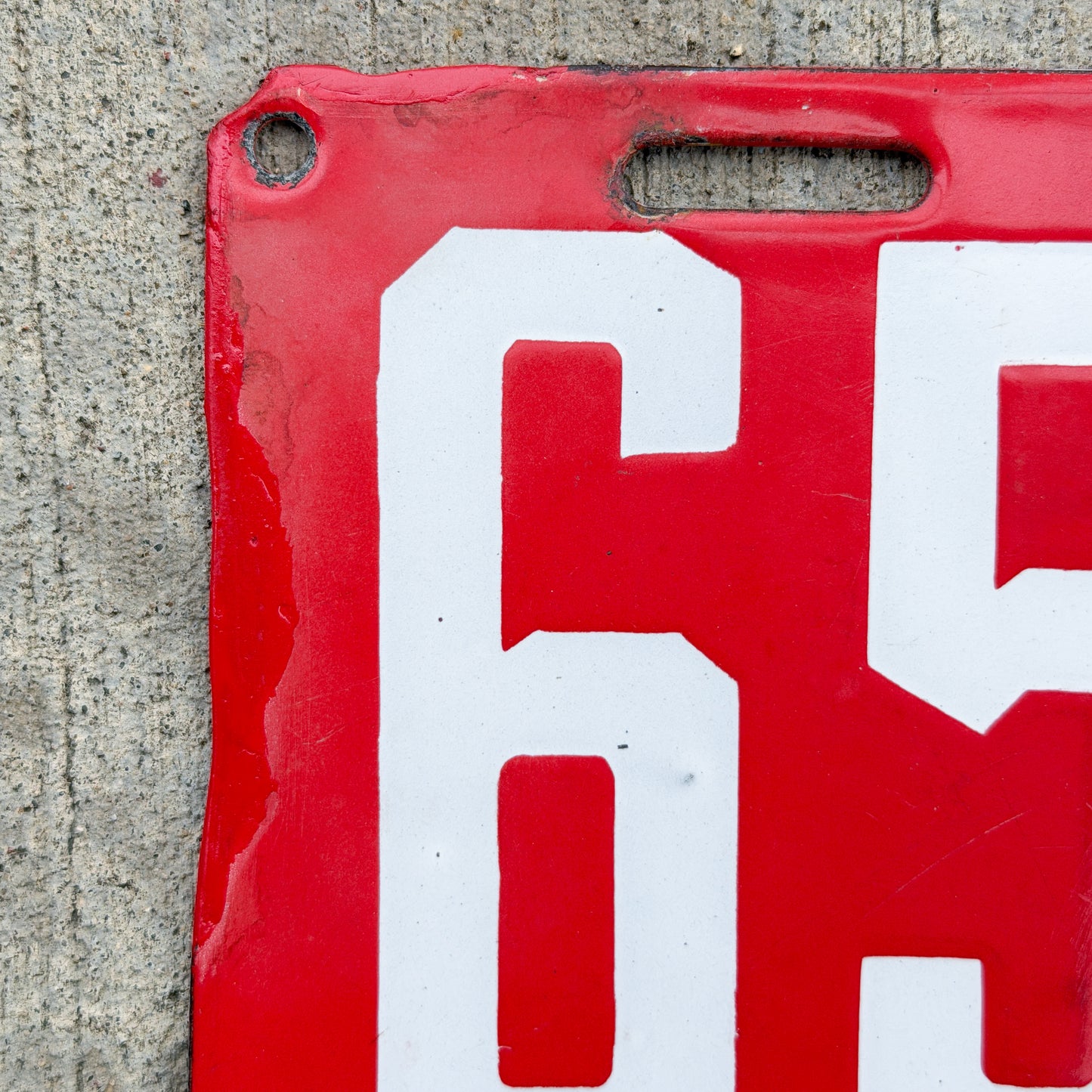 Photo of a 1915 New Brunswick Porcelain Dealer License Plate Auto Tag Garage Decor Vintage Low Number Two Digit 65 with original patina