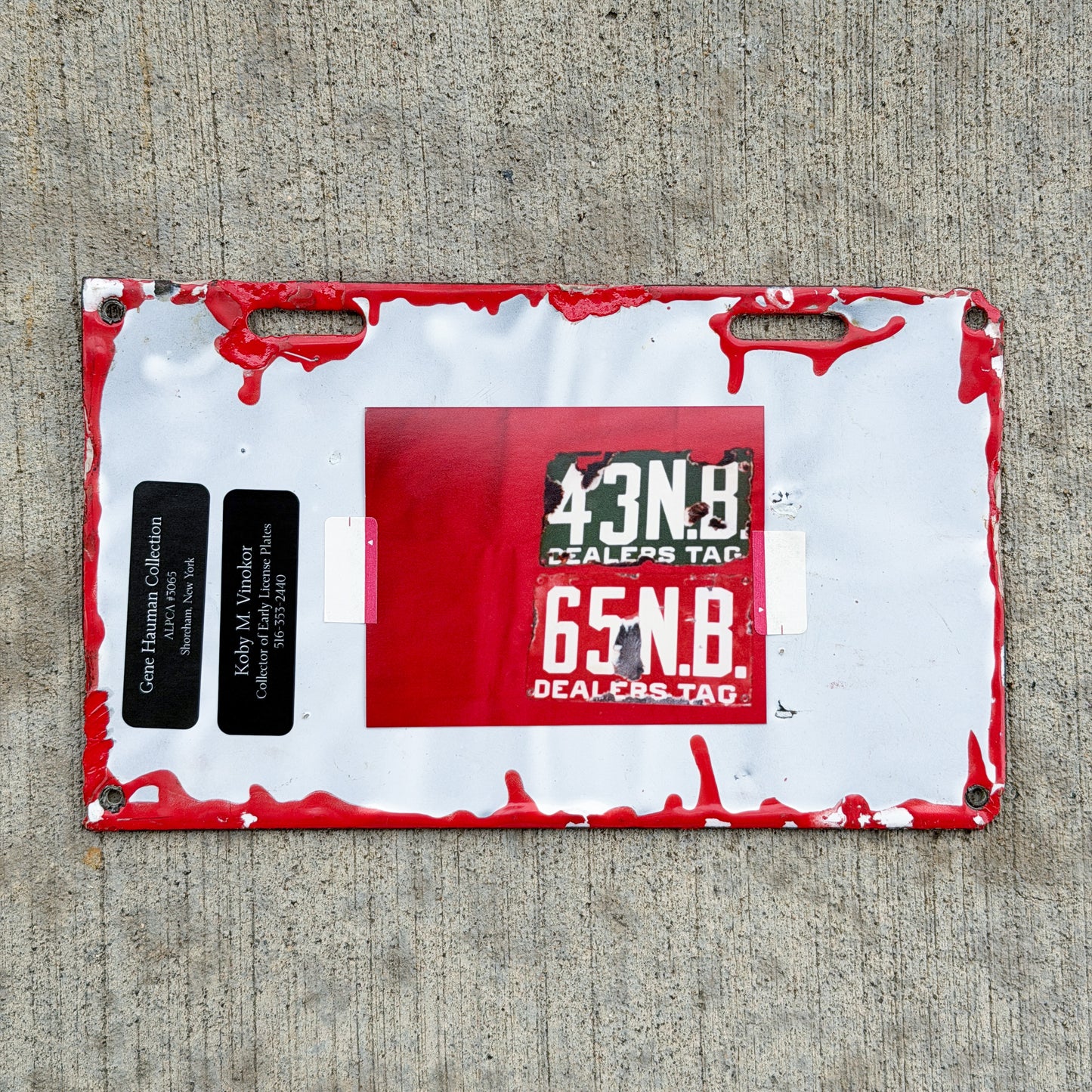 Photo of a 1915 New Brunswick Porcelain Dealer License Plate Auto Tag Garage Decor Vintage Low Number Two Digit 65 with original patina