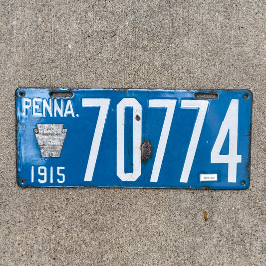 Photo of a 1915 Pennsylvania Porcelain License Plate Auto Tag Garage Decor Vintage Debossed 70774 with original patina