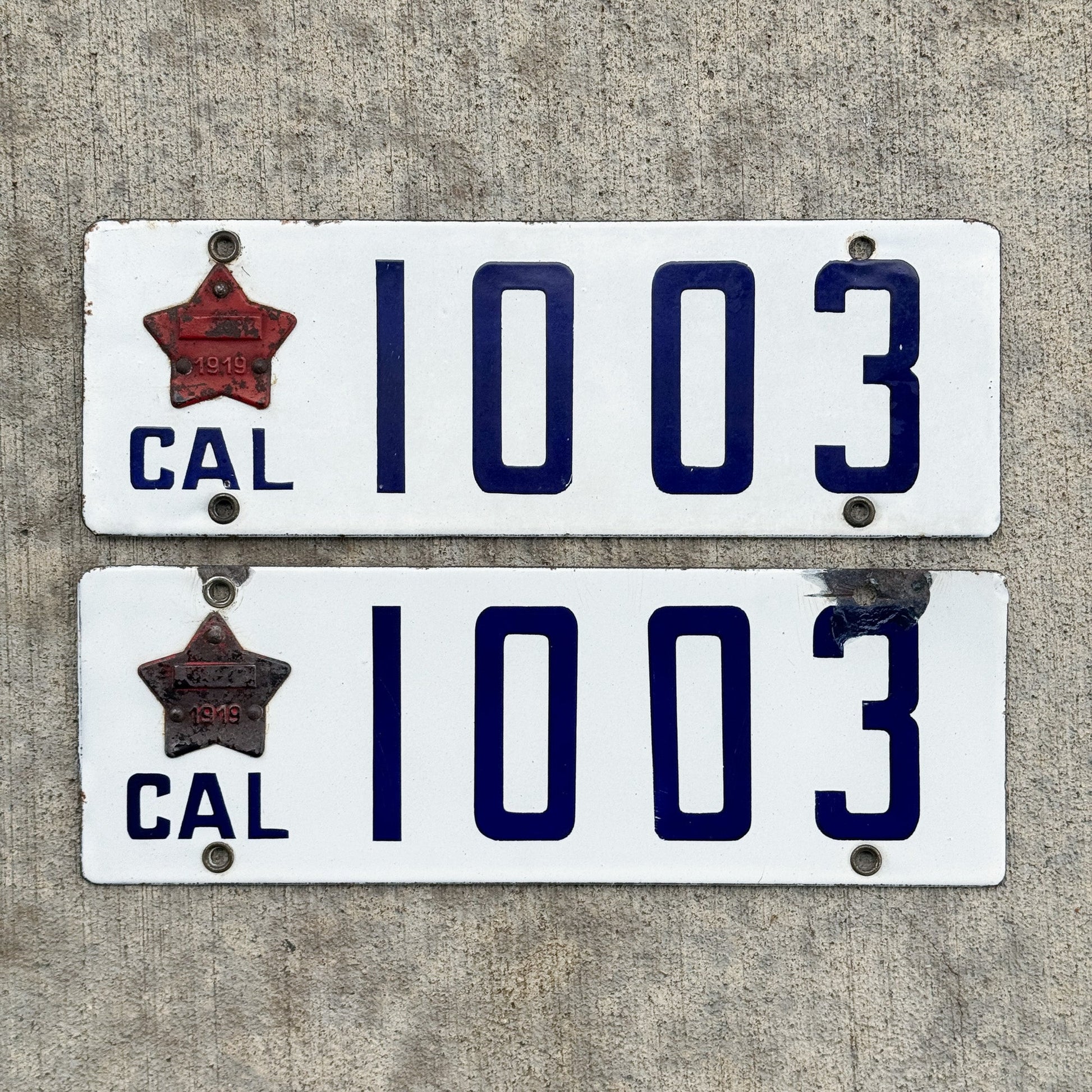 Photo of a 1916 1919 California Porcelain License Plate Pair Auto Tag Garage Decor Vintage Matching Star Badge Low Number Four Digit 1003 with original patina