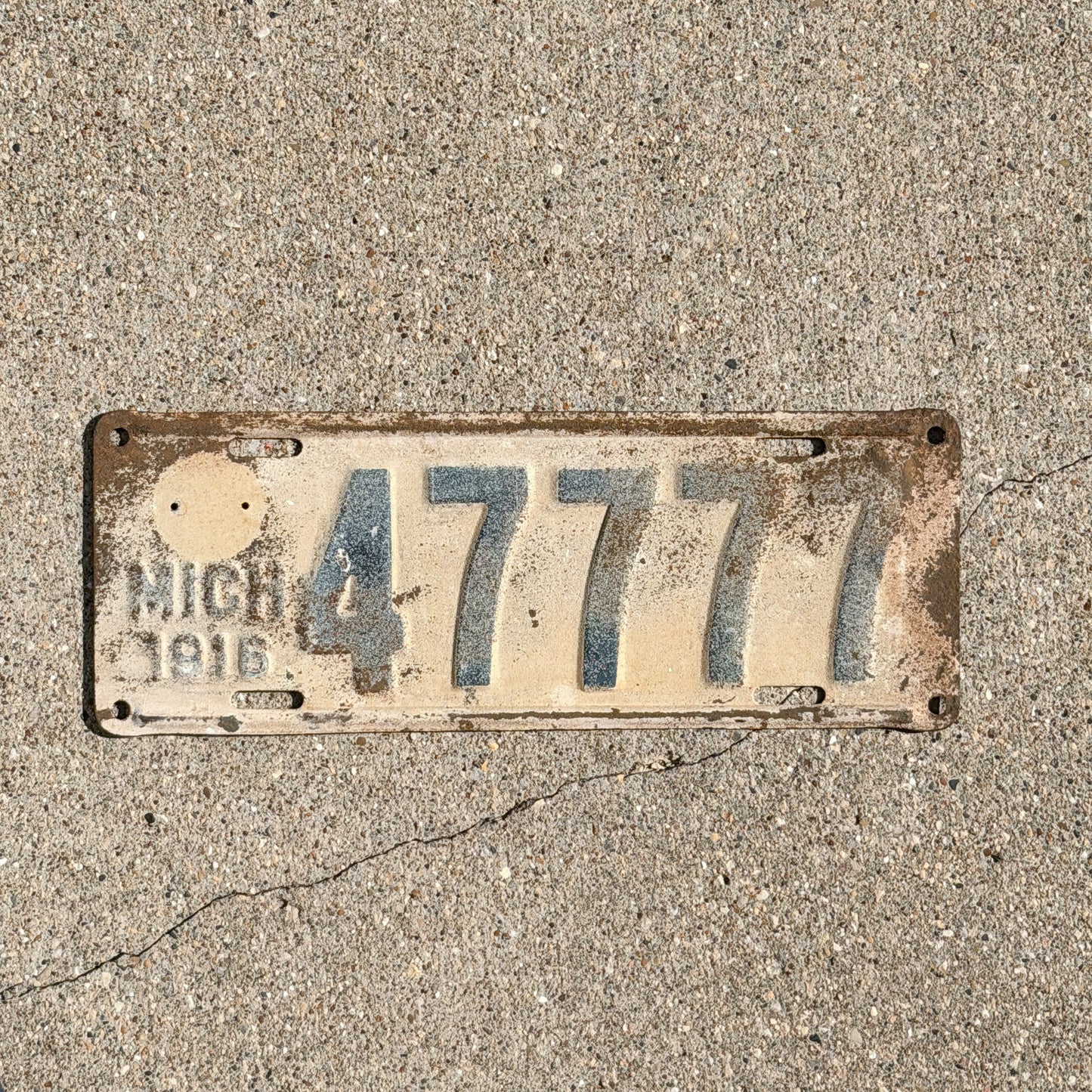 Photo of a 1916 Michigan License Plate Auto Tag Garage Decor Vintage Lucky 7 Repeat Repeating 47777 with original patina