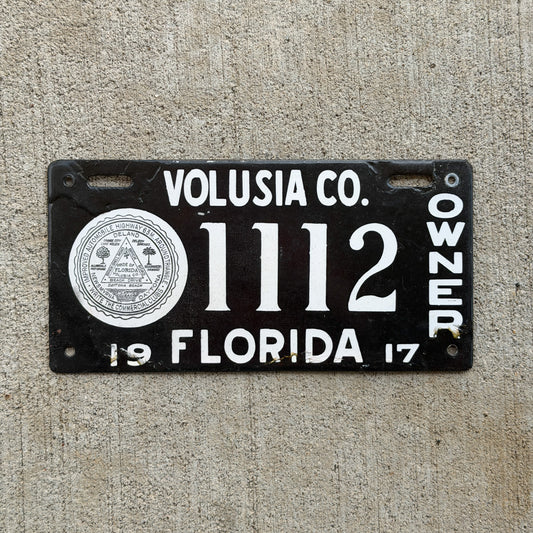 Photo of a 1917 Florida Porcelain License Plate Auto Tag Garage Decor Vintage Volusia County Repeat Repeating 1112 with original patina