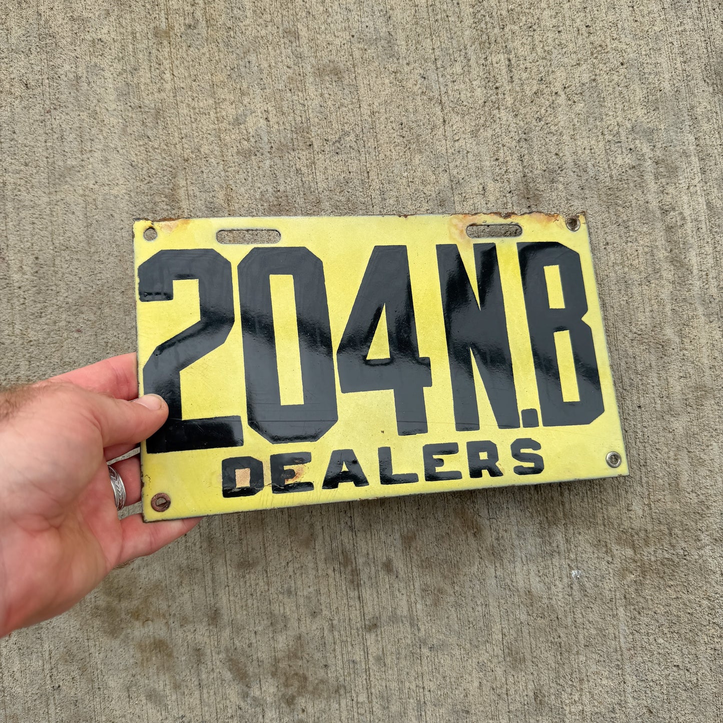 Photo of a 1917 New Brunswick Porcelain Dealer License Plate Auto Tag Garage Decor Vintage High Quality 204 with original patina