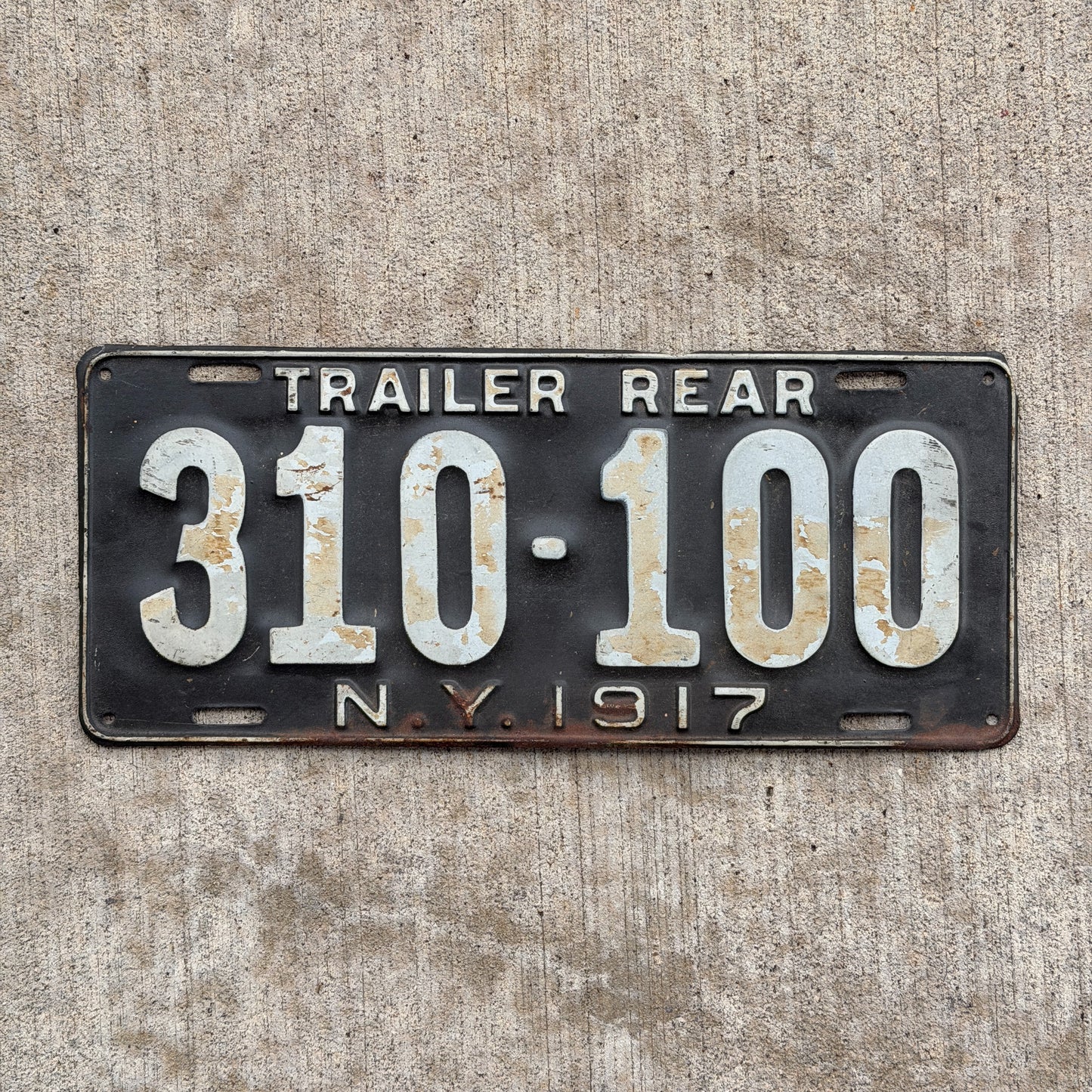 Photo of a 1917 New York Trailer License Plate Auto Tag Garage Decor Vintage Hard to Find Type 310 100 with original patina