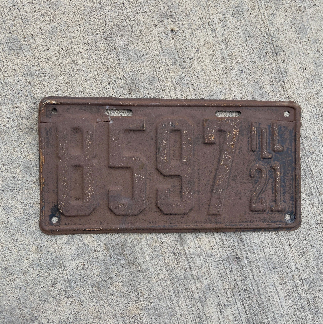 Photo of a 1921 Illinois License Plate Auto Tag Garage Decor Vintage Low Number Four Digit 8597 with original patina