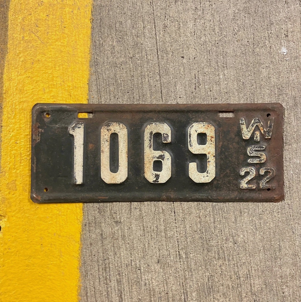 Photo of a 1922 Wisconsin License Plate Auto Tag Garage Decor Vintage Low Number Four Digit 1069 with original patina