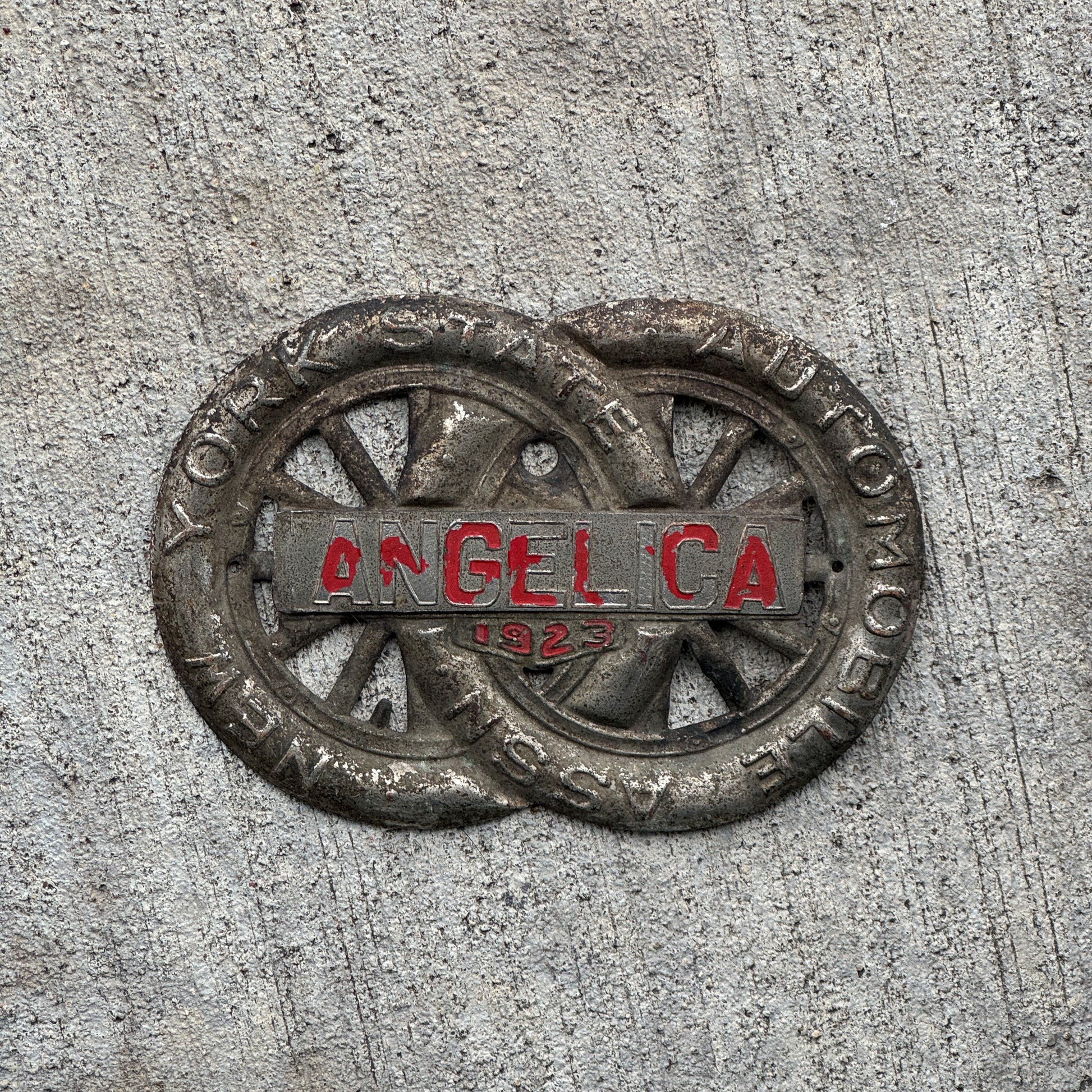 Photo of a 1923 Angelica New York Badge Emblem License Plate Topper Auto Tag Garage Decor Vintage Motor Club with original patina