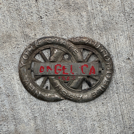 Photo of a 1923 Angelica New York Badge Emblem License Plate Topper Auto Tag Garage Decor Vintage Motor Club with original patina