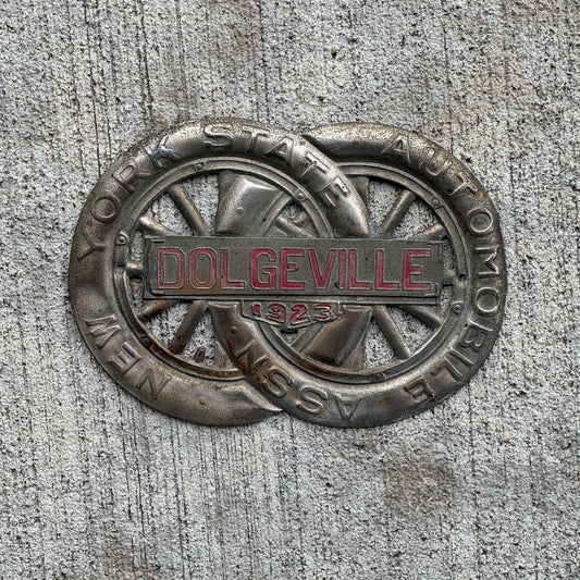 Photo of a 1923 Dolgeville New York Badge Emblem License Plate Topper Auto Tag Garage Decor Vintage Motor Club with original patina