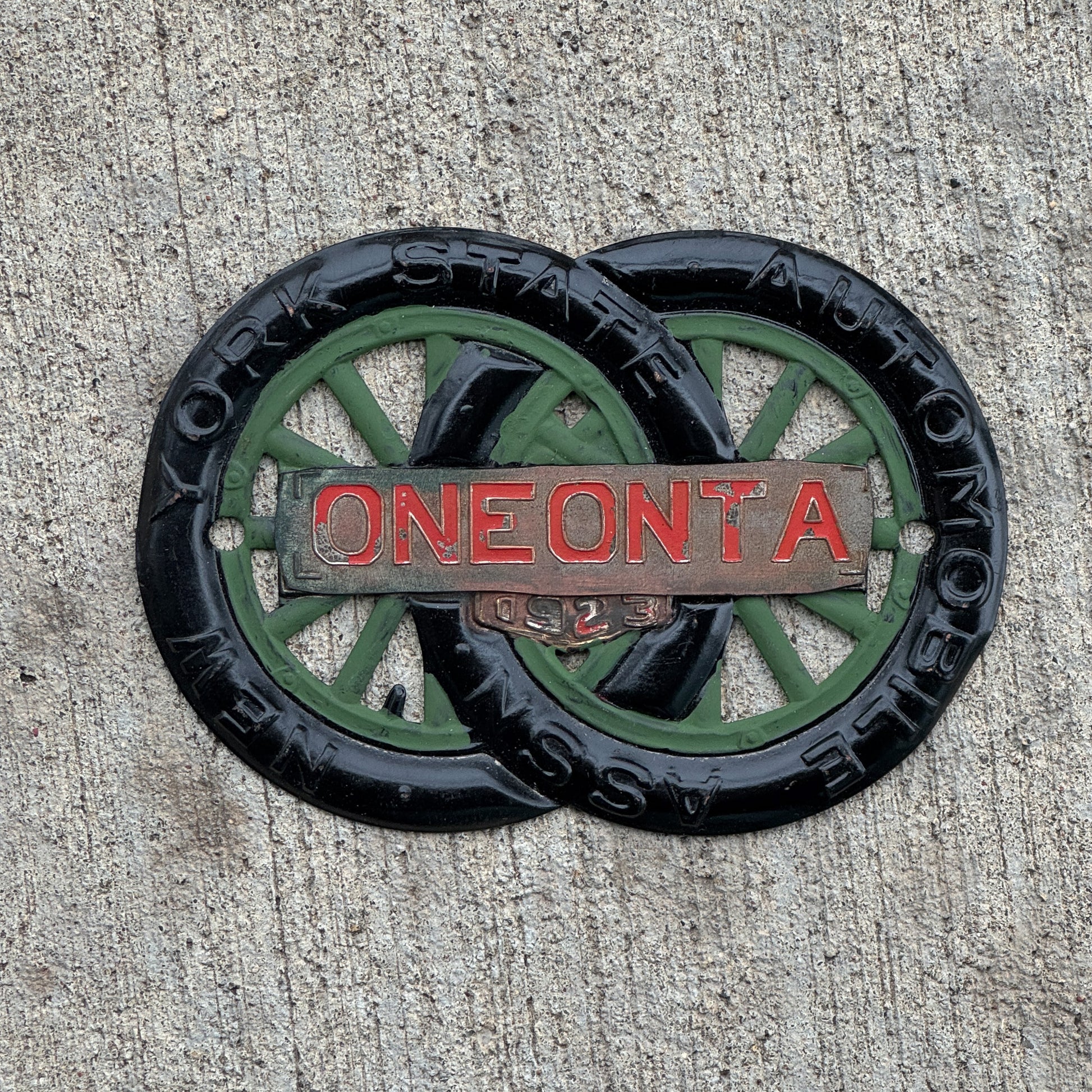 Photo of a 1923 Oneonta New York Badge Emblem License Plate Topper Auto Tag Garage Decor Vintage Motor Club with original patina