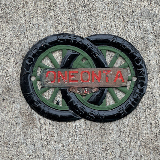 Photo of a 1923 Oneonta New York Badge Emblem License Plate Topper Auto Tag Garage Decor Vintage Motor Club with original patina