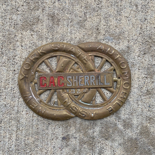 Photo of a 1924 CAC Sherrill New York License Plate Topper Auto Tag Garage Decor Vintage AAA Brass Car Badge Motor Club Automobile with original patina