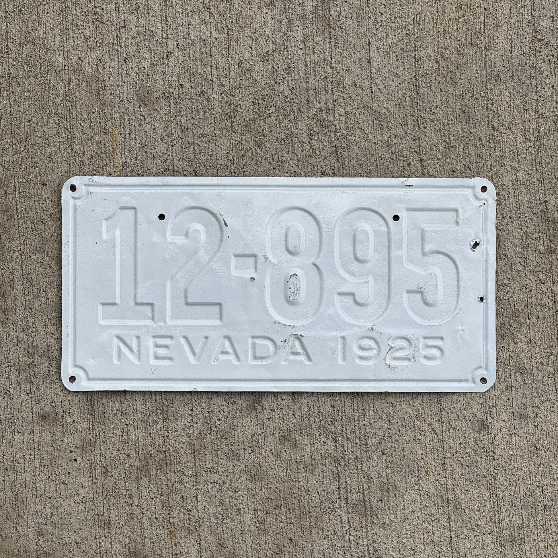Photo of a 1925 Nevada License Plate Auto Tag Garage Decor Vintage Debossed 12 895 with original patina