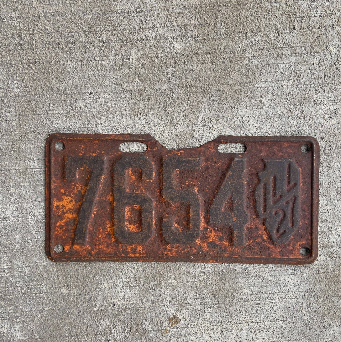 Photo of a 1927 Illinois License Plate Auto Tag Garage Decor Vintage Low Number Four Digit Iconic State Shape 7654 with original patina