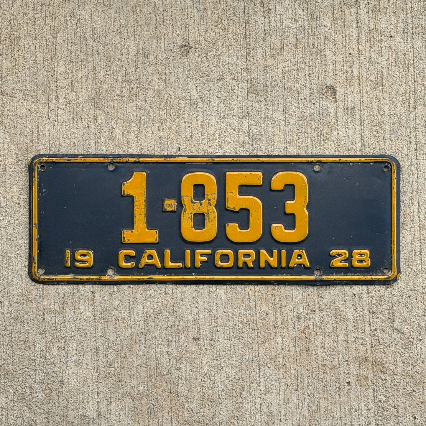 Photo of a 1928 California License Plate Auto Tag Garage Decor Vintage Ford Model A Year Low Number Four Digit 1853 with original patina