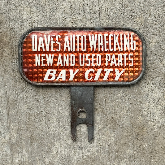 Photo of a 1930 Era Dave's Auto Wrecking Bay City Michigan License Plate Topper Auto Tag Garage Decor Vintage Snow Craggs with original patina