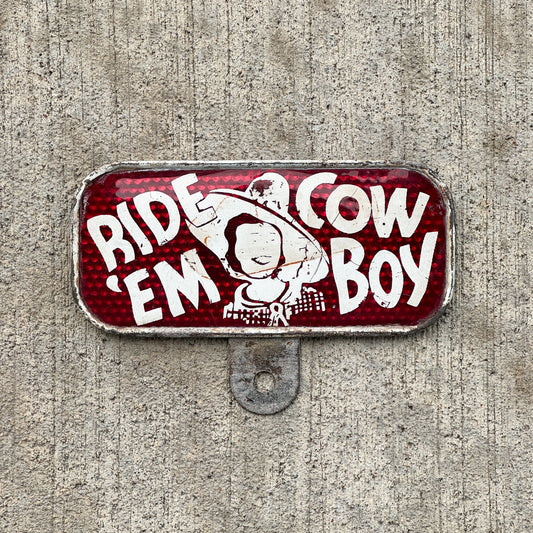 Photo of a 1930 Era Ride 'EM Cowboy License Plate Topper Auto Tag Garage Decor Vintage Snow Craggs with original patina