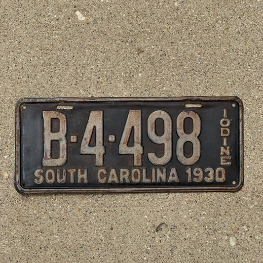 Vintage South Carolina license plate from 1930 on a concrete surface