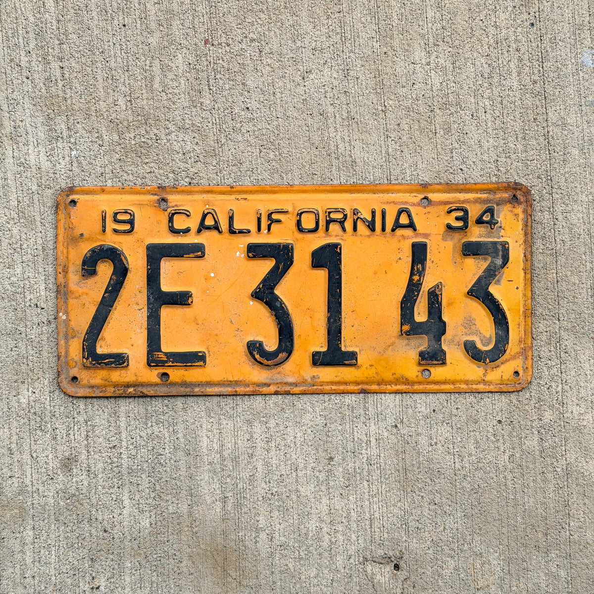 Photo of a 1934 California License Plate Auto Tag Garage Decor Vintage 2 E 3143 with original patina