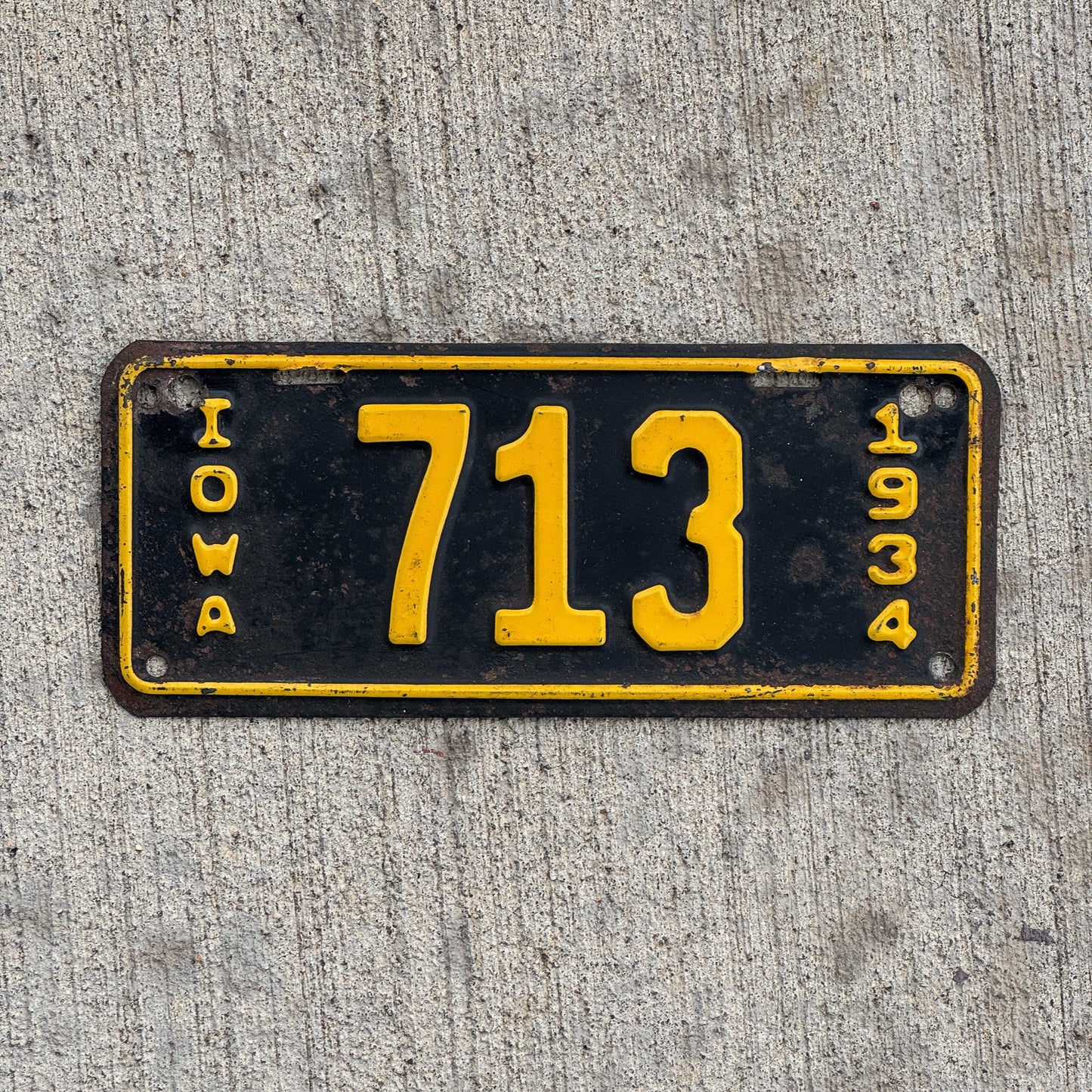 Photo of a 1934 Iowa Motorcycle License Plate Auto Tag Garage Decor Vintage Low Number Three Digit 713 with original patina