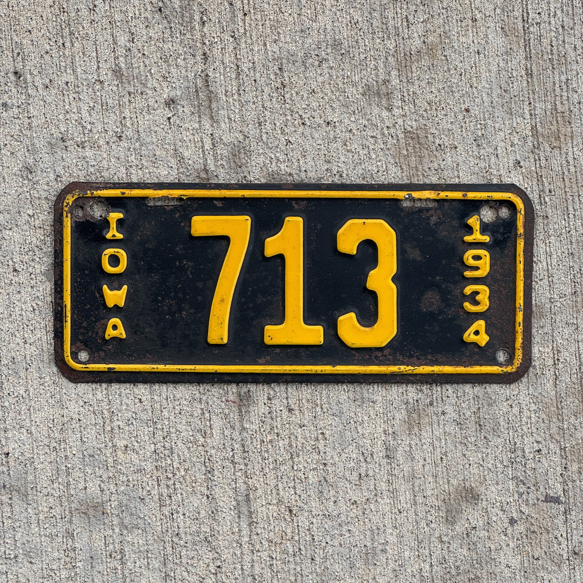 Photo of a 1934 Iowa Motorcycle License Plate Auto Tag Garage Decor Vintage Low Number Three Digit 713 with original patina