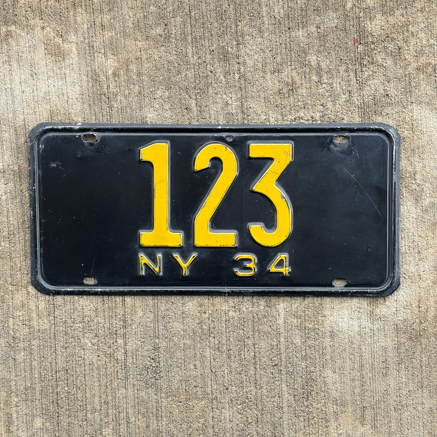 Photo of a 1934 New York Reserved License Plate Auto Tag Garage Decor Vintage ALPCA Archive Example Low Number Three Digit 123 with original patina