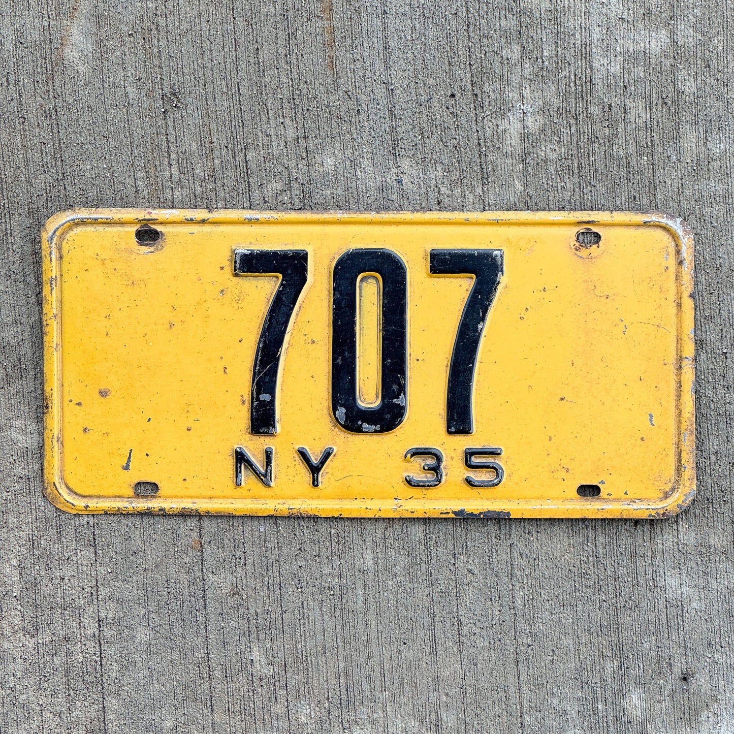 Photo of a 1935 New York Reserved License Plate Auto Tag Garage Decor Vintage ALPCA Archive Example Low Number Three Digit 707 with original patina
