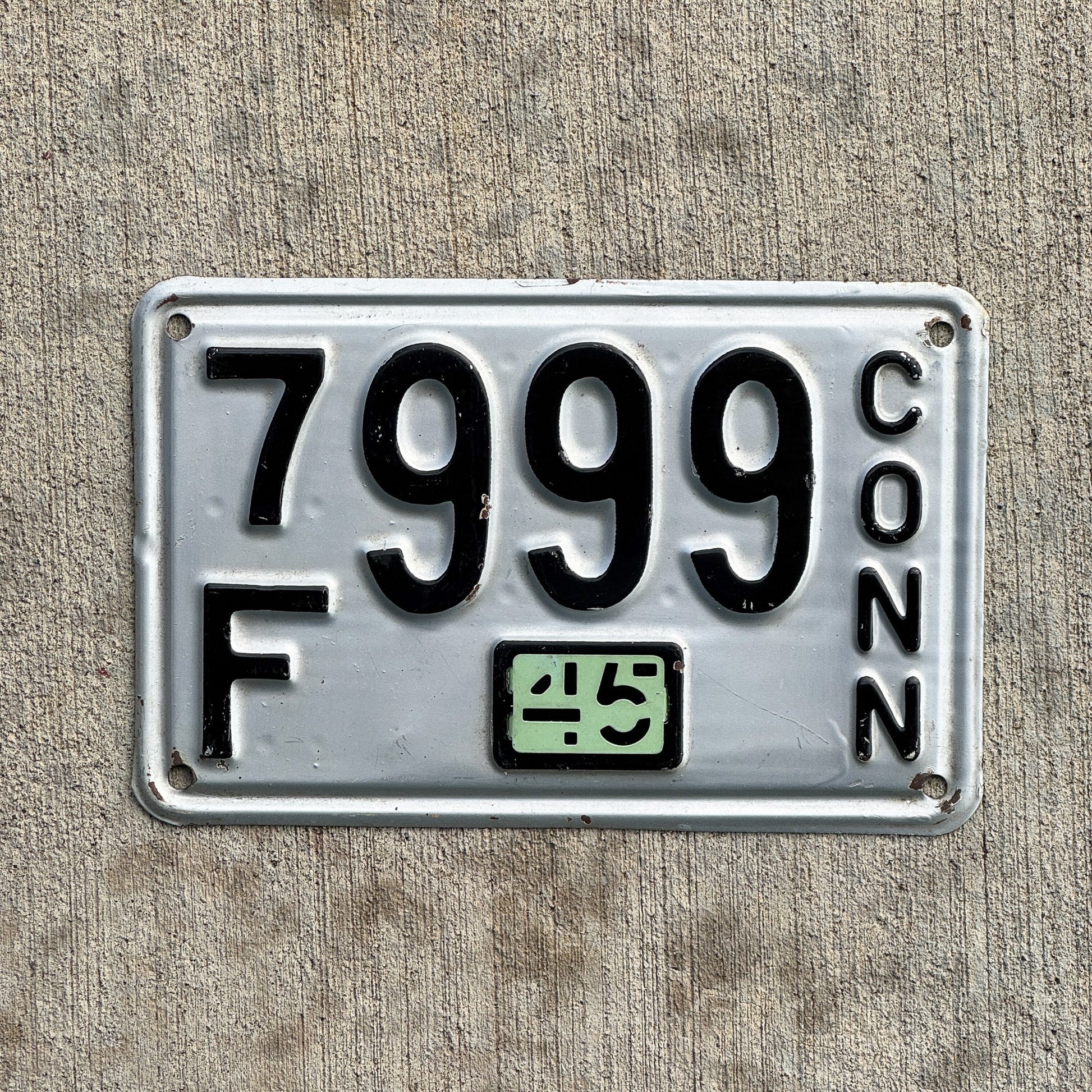 Photo of a 1937 1945 Connecticut License Plate Auto Tag Garage Decor Vintage Repeat Repeating 7F 999 with original patina