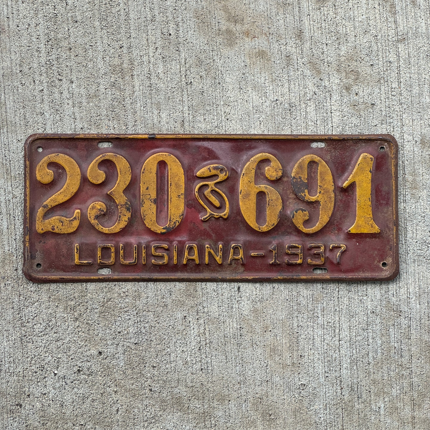 Photo of a 1937 Louisiana License Plate Auto Tag Garage Decor Vintage Iconic Pelican 230 691 with original patina