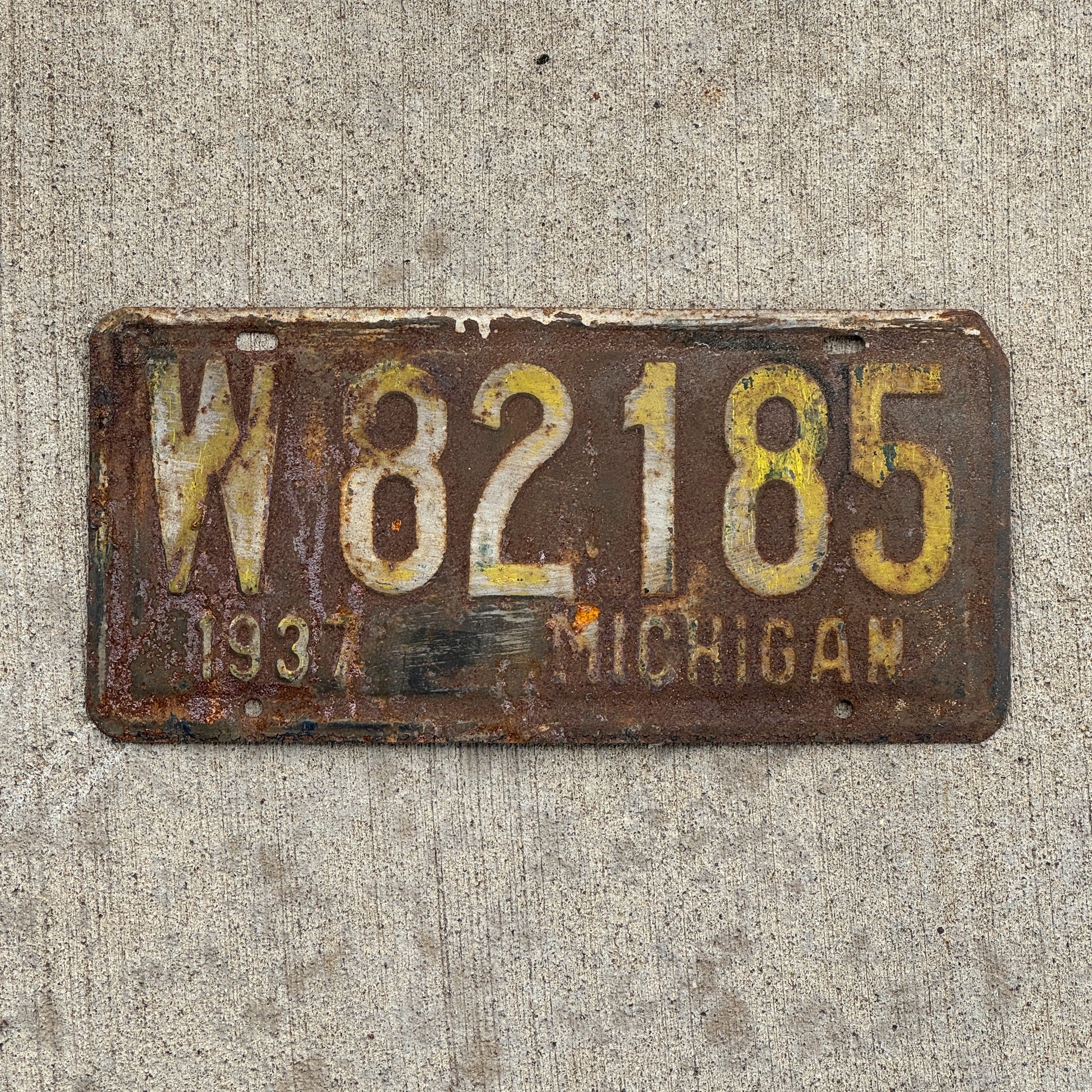 Photo of a 1937 Michigan License Plate Auto Tag 2 Vintage Garage W 82185 with original patina