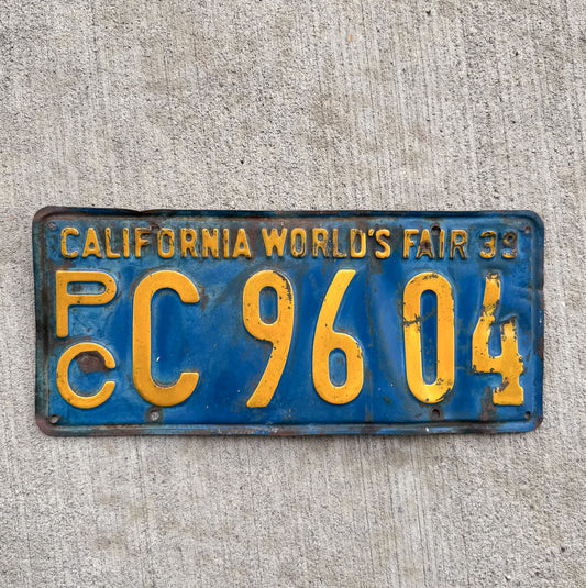 Photo of a 1939 California Commercial License Plate Auto Tag Garage Decor Vintage World's Fair PC 9604 with original patina