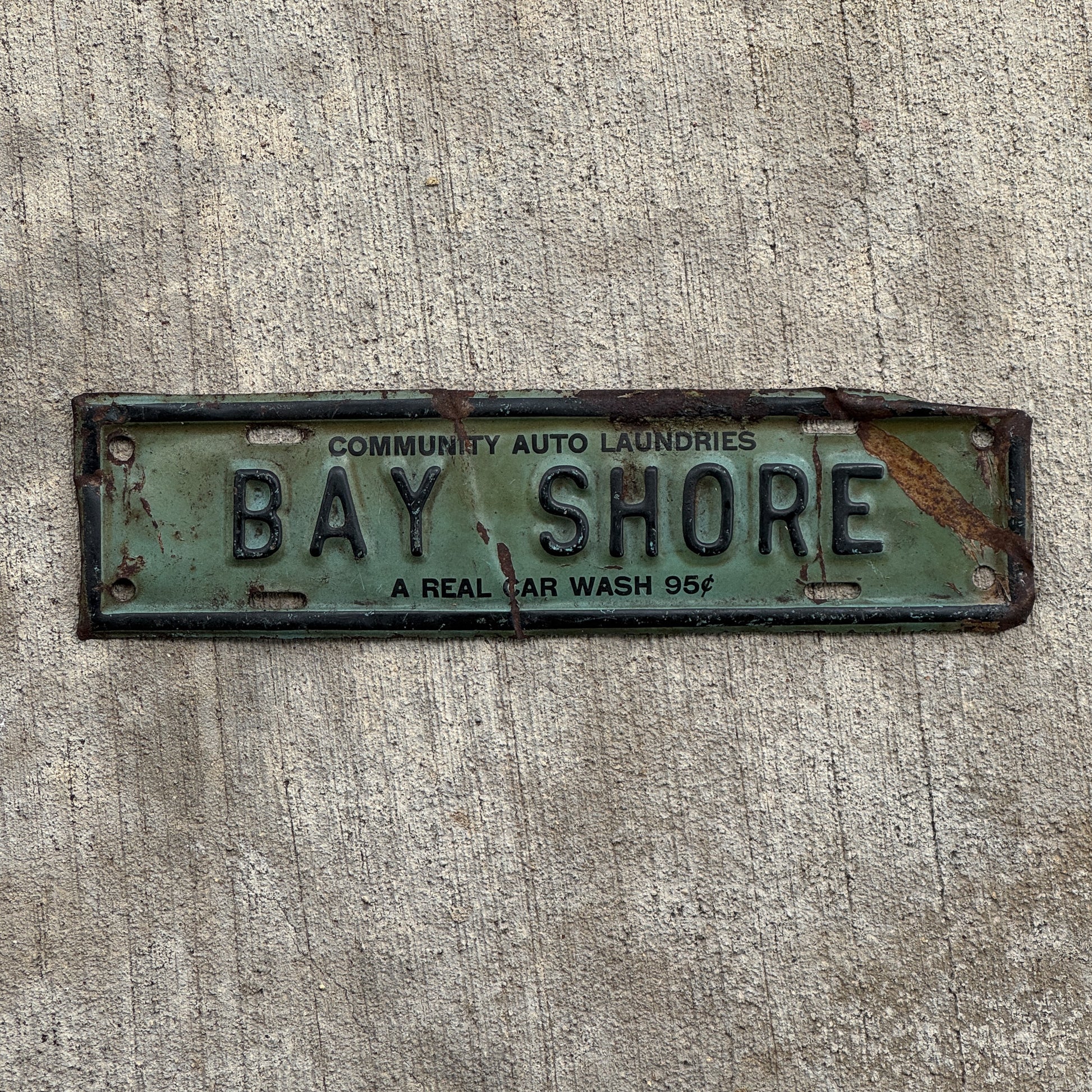 Photo of a 1940 Era Bay Shore Long Island New York License Plate Topper Auto Tag Garage Decor Vintage Community Auto Laundries Car Wash with original patina