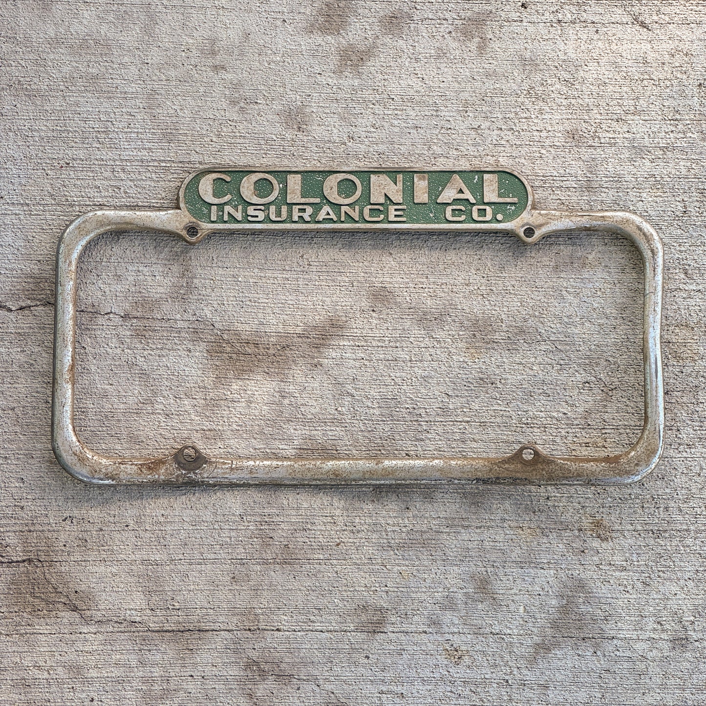 Photo of a 1940 Era California License Plate Frame Auto Tag Garage Decor Vintage Colonial Insurance Co with original patina