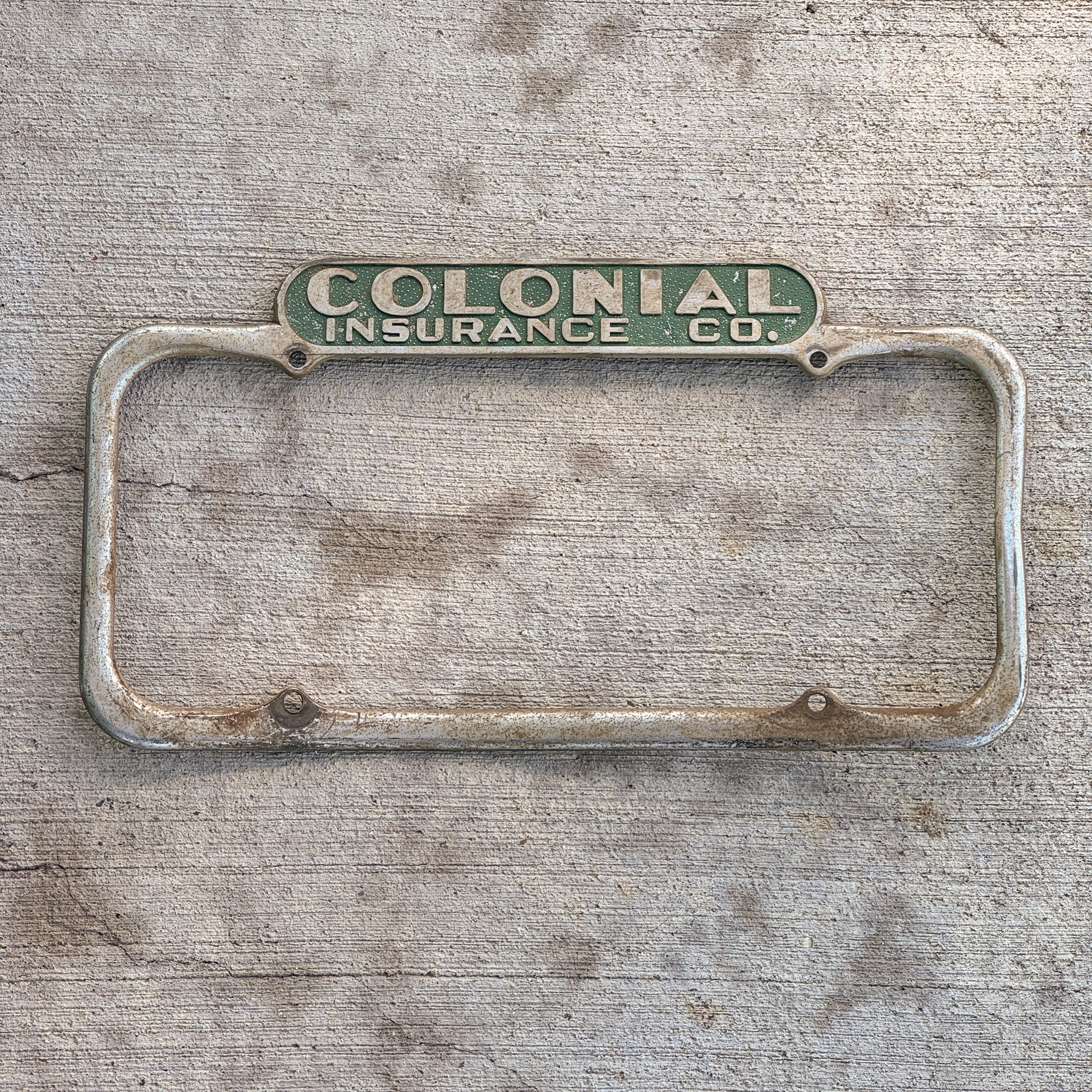 Photo of a 1940 Era California License Plate Frame Auto Tag Garage Decor Vintage Colonial Insurance Co with original patina